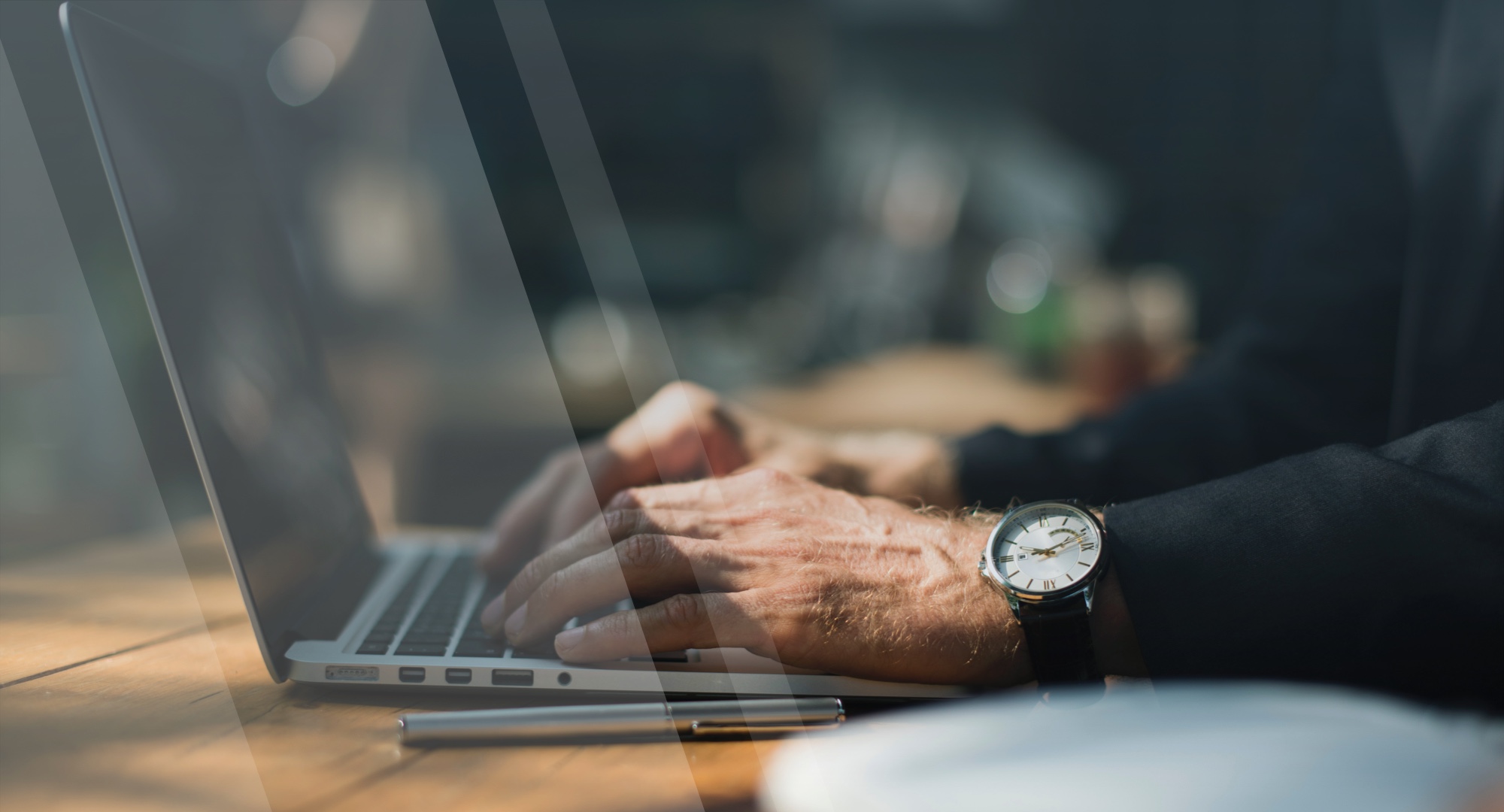 man typing on computer with watch and silver pen - Refund Policy